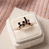 Panda Sushi Roll Ring (Opal) in rose gold, laid flat on a tabletop