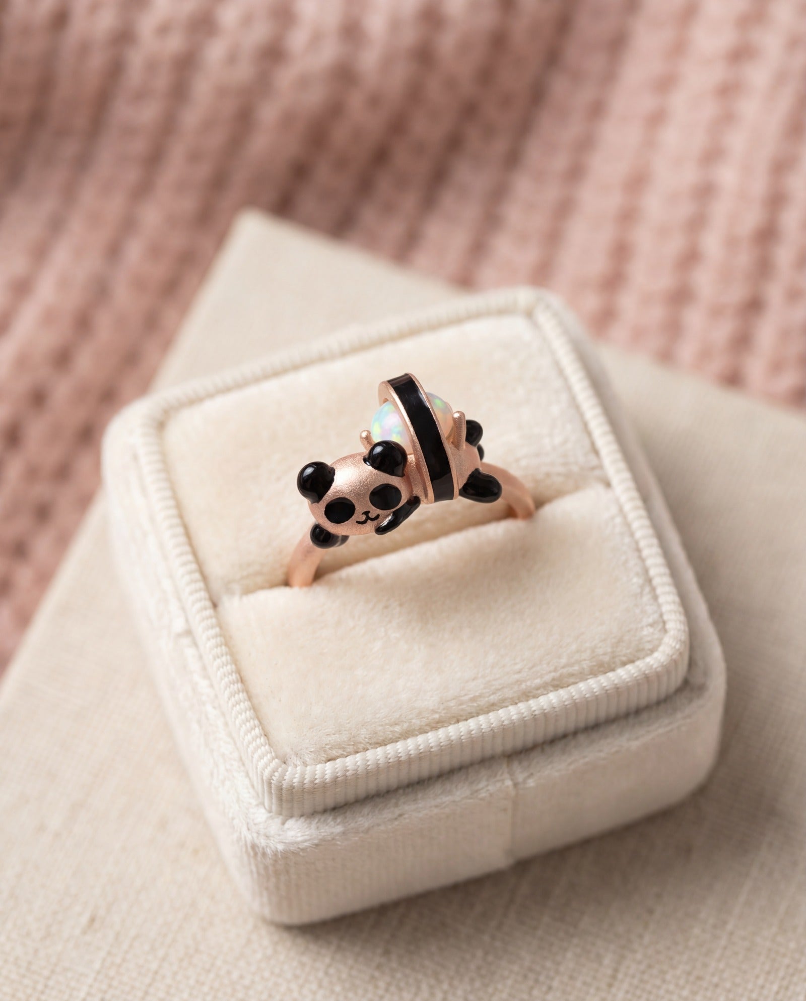Panda Sushi Roll Ring (Opal) in rose gold, laid flat on a tabletop