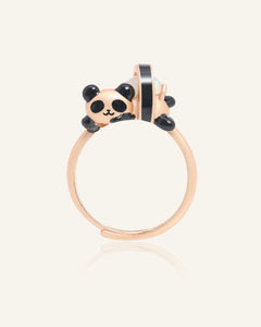 Close-up of the Panda Sushi Roll Ring (Opal) in rose gold, resting on a warm linen background
