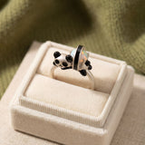 Panda Sushi Roll Ring (Opal) in silver, laid flat on a tabletop