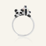 Panda Sushi Roll Ring (Opal) in silver, resting on a warm linen background