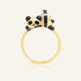 Panda Sushi Roll Ring (Opal) in yellow gold, resting on a warm linen background