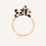 Panda Sushi Roll Ring (Peridot) in rose gold, resting on a warm linen background