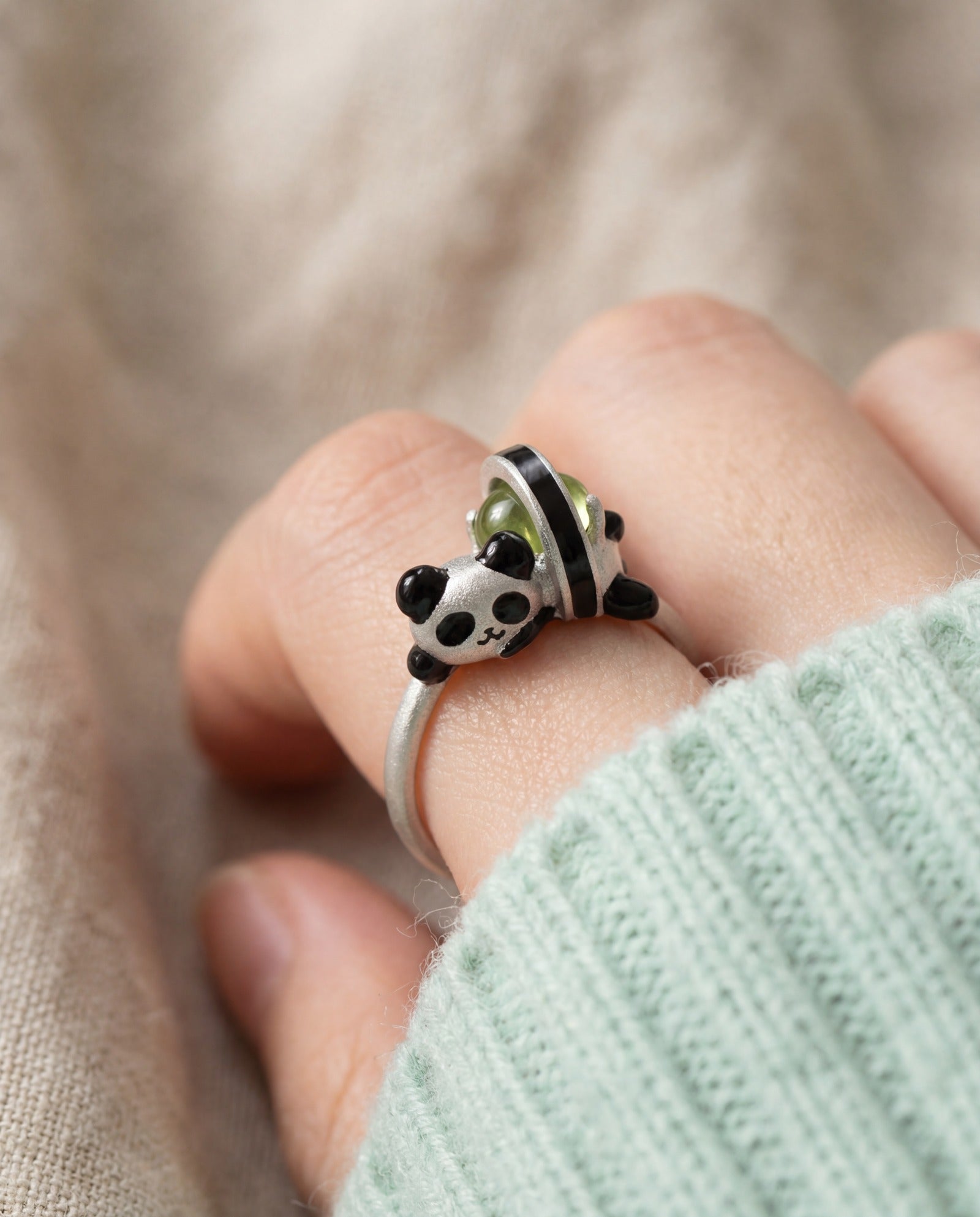 Panda Sushi Roll Ring (Peridot) in silver, worn on a model