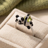 Panda Sushi Roll Ring (Peridot) in silver, laid flat on a tabletop