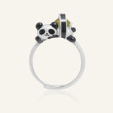 Close-up of the Panda Sushi Roll Ring (Peridot) in silver, resting on a warm linen background