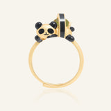 Panda Sushi Roll Ring (Peridot) in yellow gold, resting on a warm linen background
