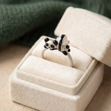 Panda Sushi Roll Ring (White Jade) in silver, laid flat on a tabletop