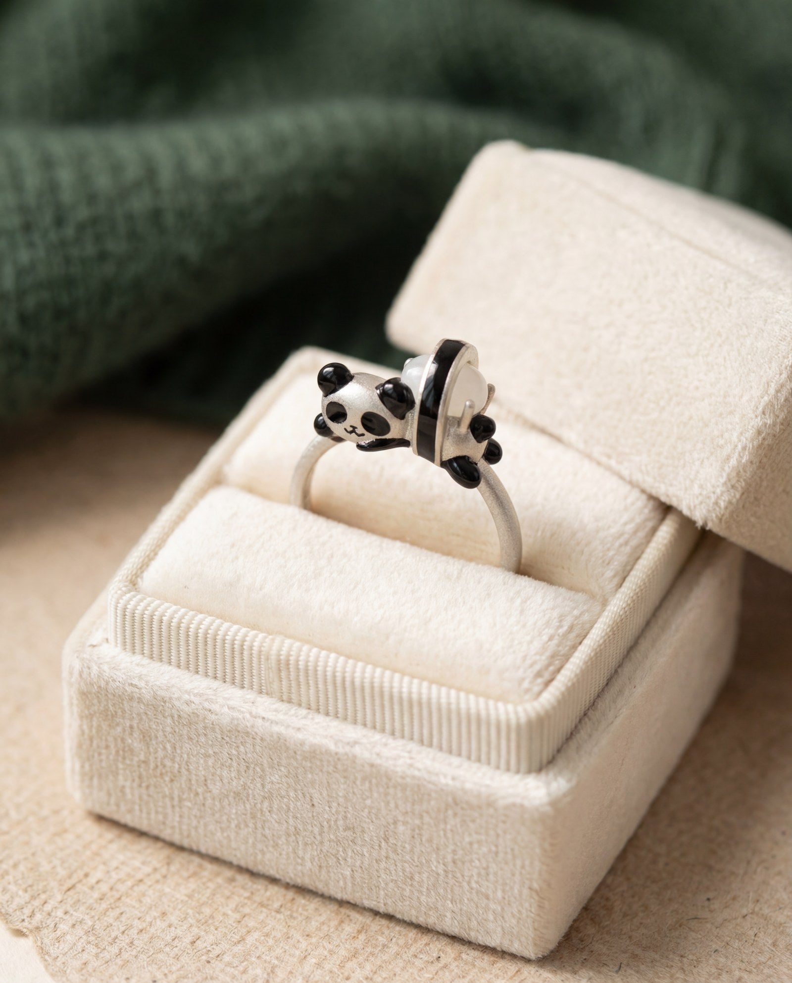 Panda Sushi Roll Ring (White Jade) in silver, laid flat on a tabletop
