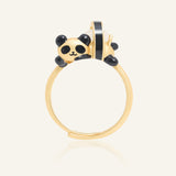 Panda Sushi Roll Ring (White Jade) in yellow gold, resting on a warm linen background