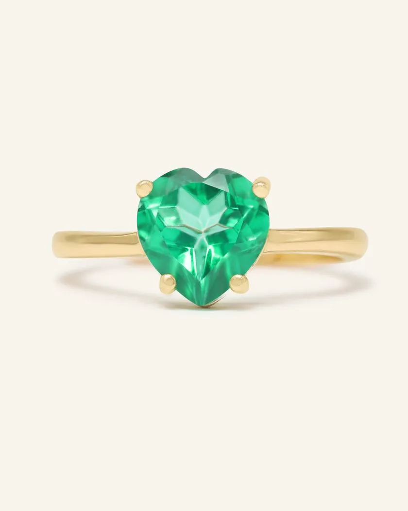 Paraiba topaz heart ring set in yellow gold, featuring a vibrant green heart-shaped gemstone with a polished band.
