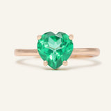 Paraiba Topaz Heart Ring | XL in rose gold, resting on a warm linen background