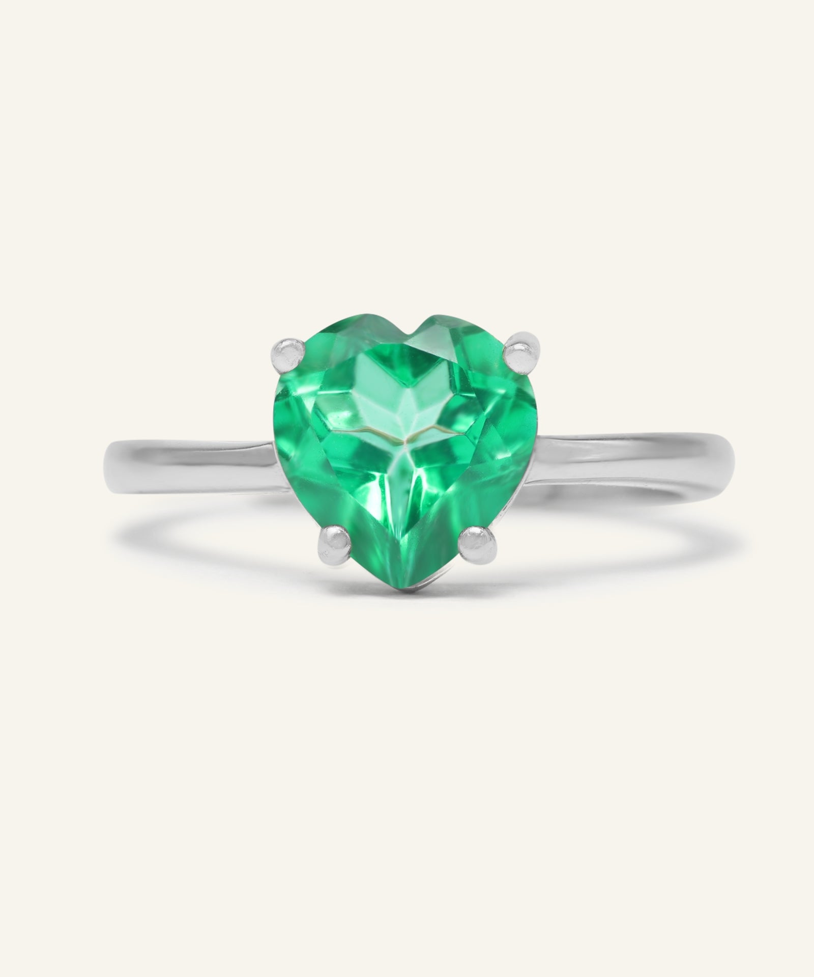 Paraiba Topaz Heart Ring | XL in silver, resting on a warm linen background
