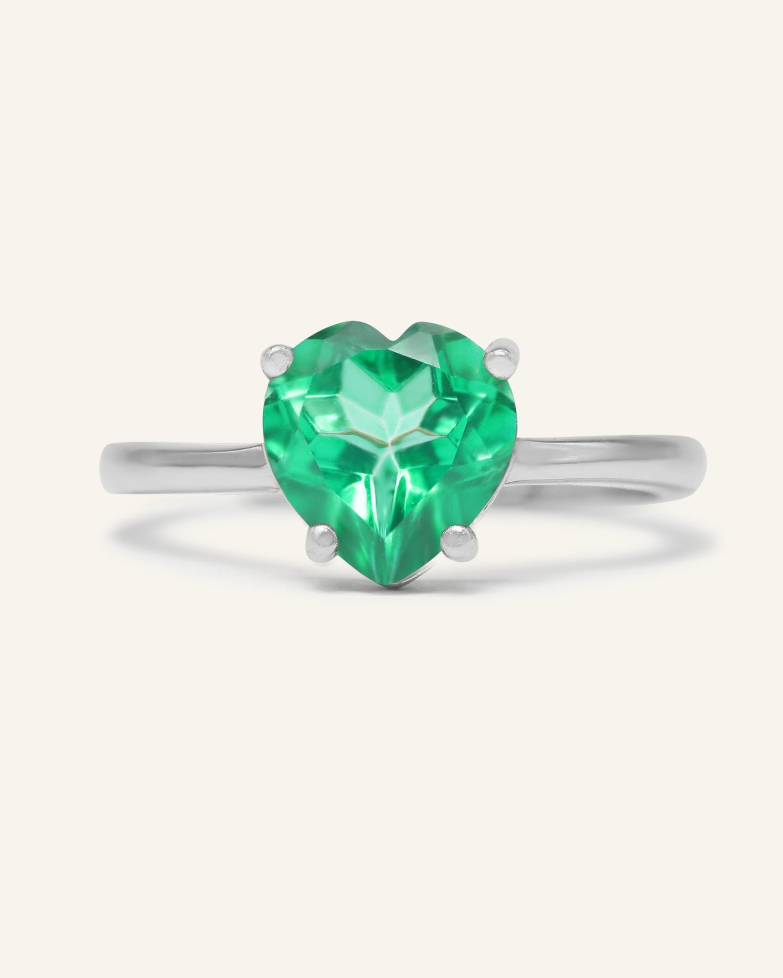 Paraiba Topaz Heart Ring | XL in silver, resting on a warm linen background