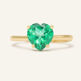 Close-up of the Paraiba Topaz Heart Ring | XL in yellow gold, resting on a warm linen background