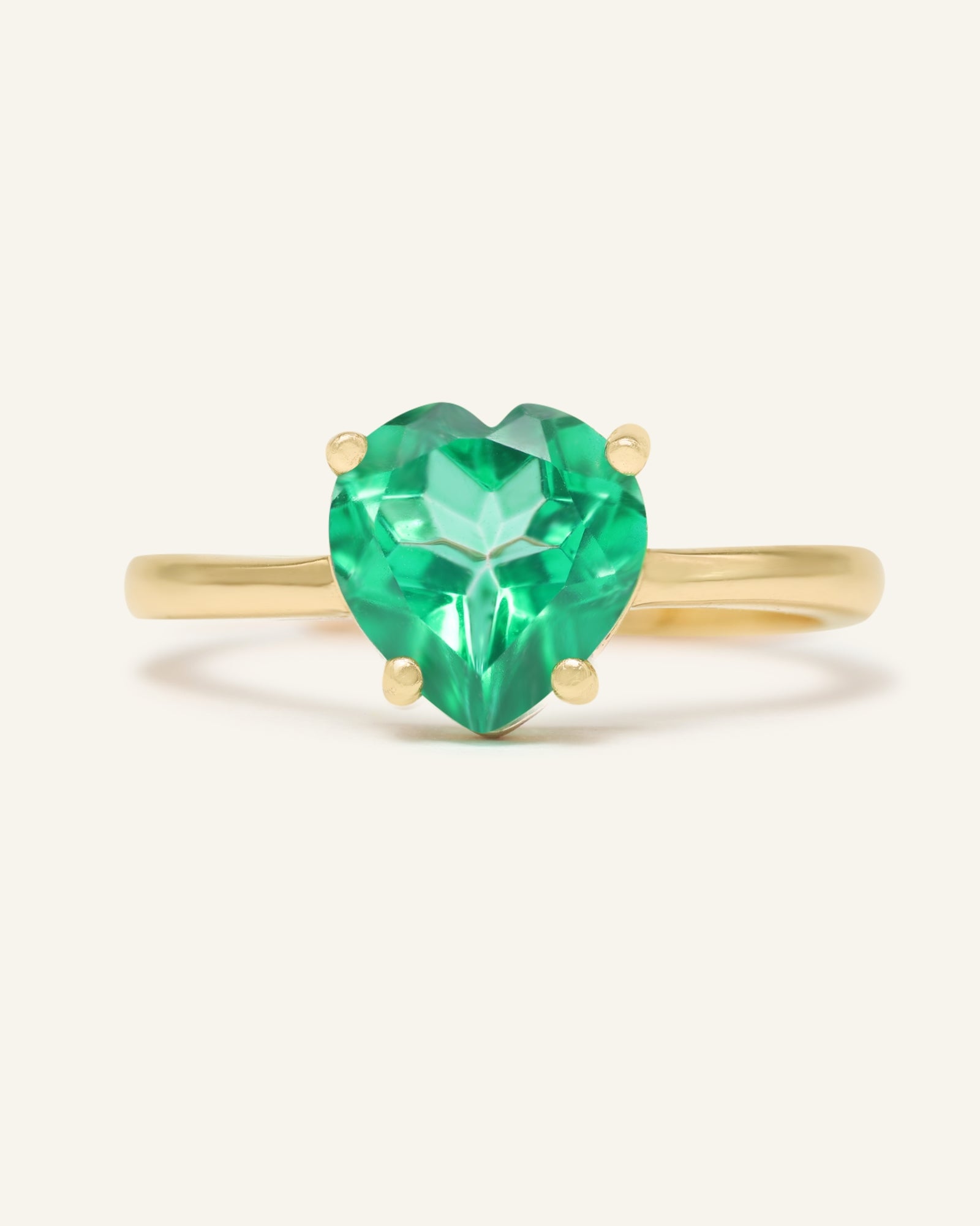 Close-up of the Paraiba Topaz Heart Ring | XL in yellow gold, resting on a warm linen background