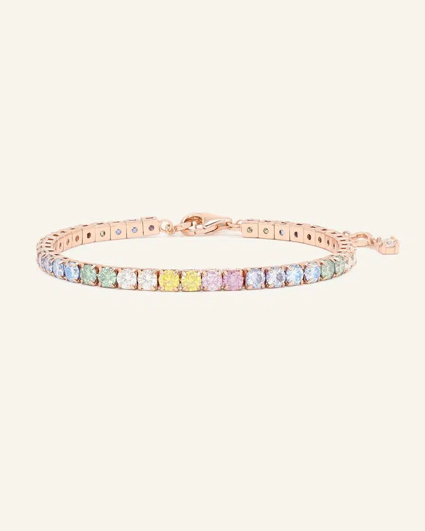 A pastel moissanite tennis bracelet featuring a row of round-cut moissanite stones in soft shades of ice blue, green, yellow, pink, and lilac, set in rose gold.	