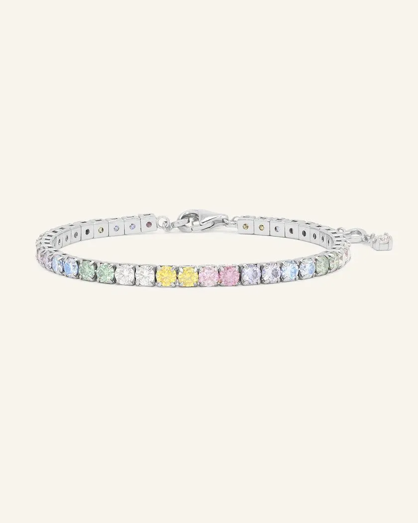 A pastel moissanite tennis bracelet featuring a row of round-cut moissanite stones in soft shades of ice blue, green, yellow, pink, and lilac, set in silver.