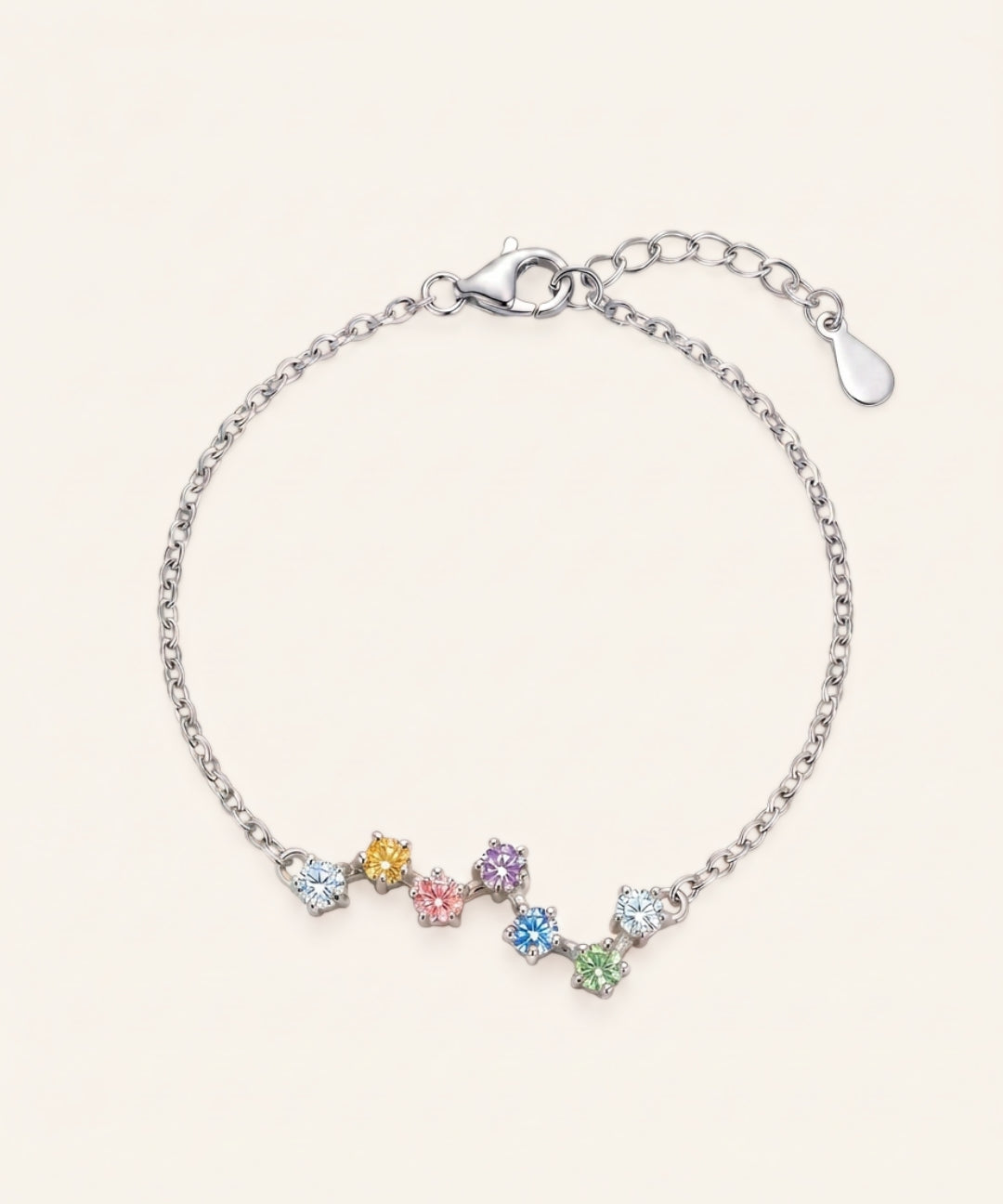A top-down studio product photograph of the Pastel Constellation Moissanite Bracelet in silver, displaying the organic constellation layout of soft pastel moissanite stones on a crisp white background.