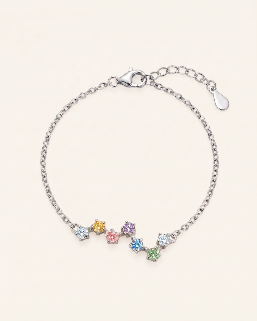 A top-down studio product photograph of the Pastel Constellation Moissanite Bracelet in silver, displaying the organic constellation layout of soft pastel moissanite stones on a crisp white background.
