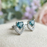 Macro photograph of Petite Blue Tourmaline Heart Studs showing the intricate pavé setting and heart-cut gemstone detail.