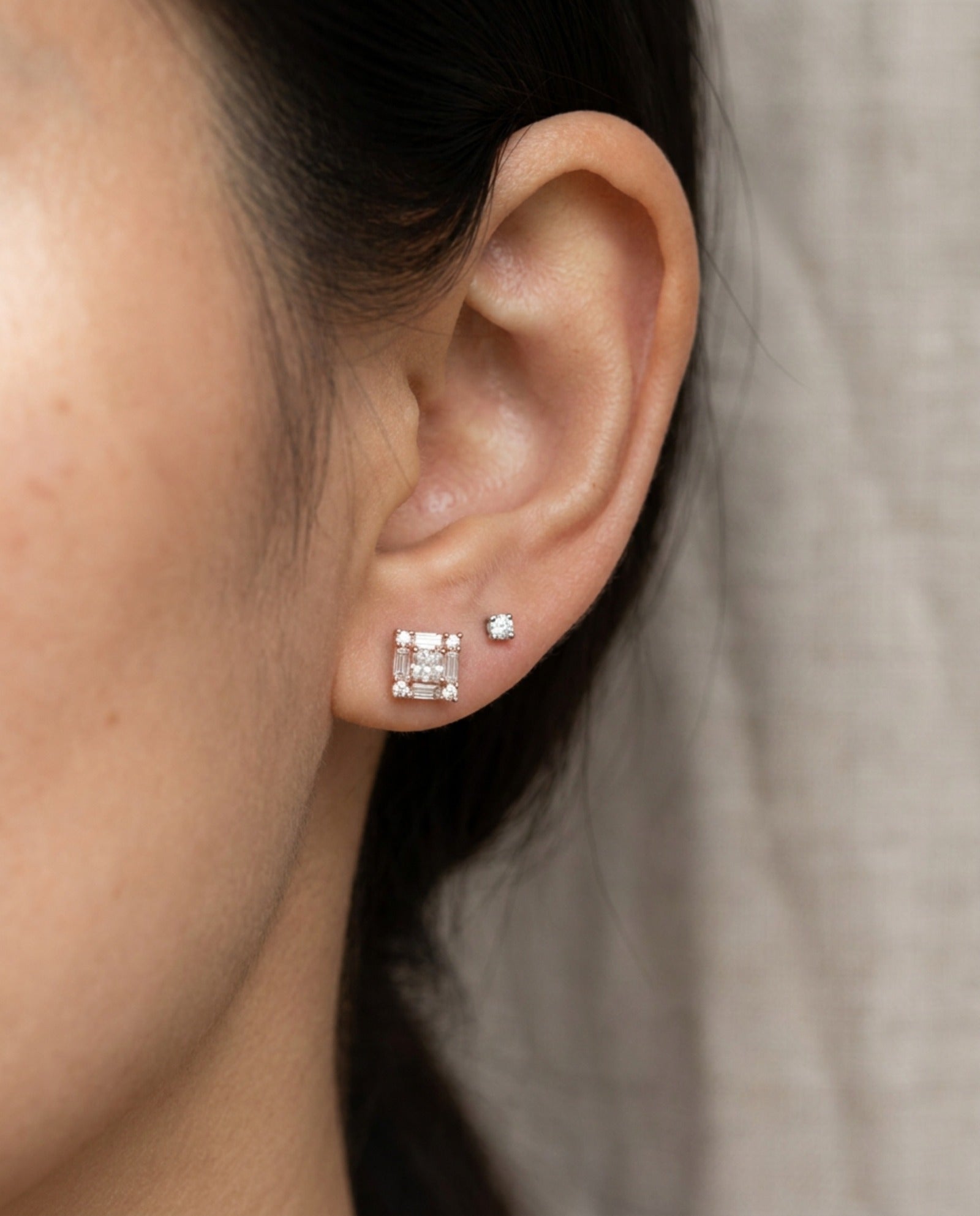 Ear stack featuring 18k rose gold Petite Princess Mosaic Moissanite Stud paired with a small round solitaire stud.