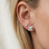 Model wearing sterling silver Petite Princess Mosaic Moissanite Stud in first lobe piercing alongside a small accent stud.