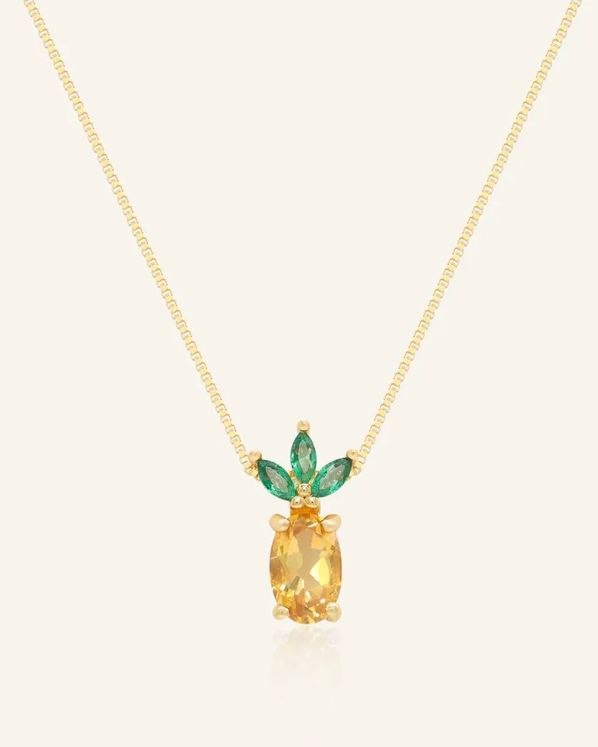 Yellow gold pineapple citrine necklace featuring a vibrant oval-cut citrine gemstone as the centerpiece, accented with marquise-cut green cubic zirconias forming the crown-like leaves.