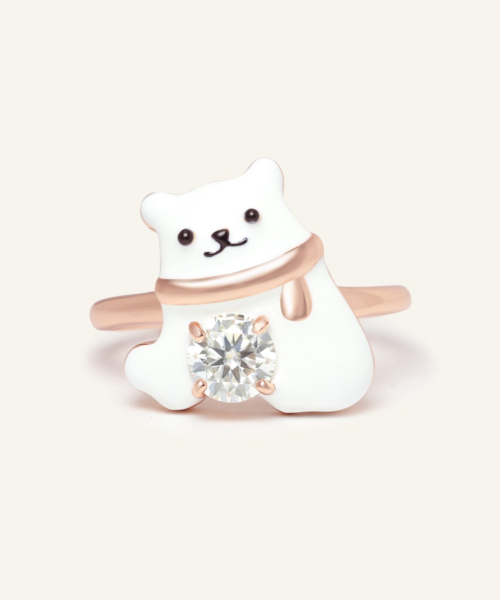 Close-up of the Polar Bear Moissanite Ring in rose gold, resting on a warm linen background