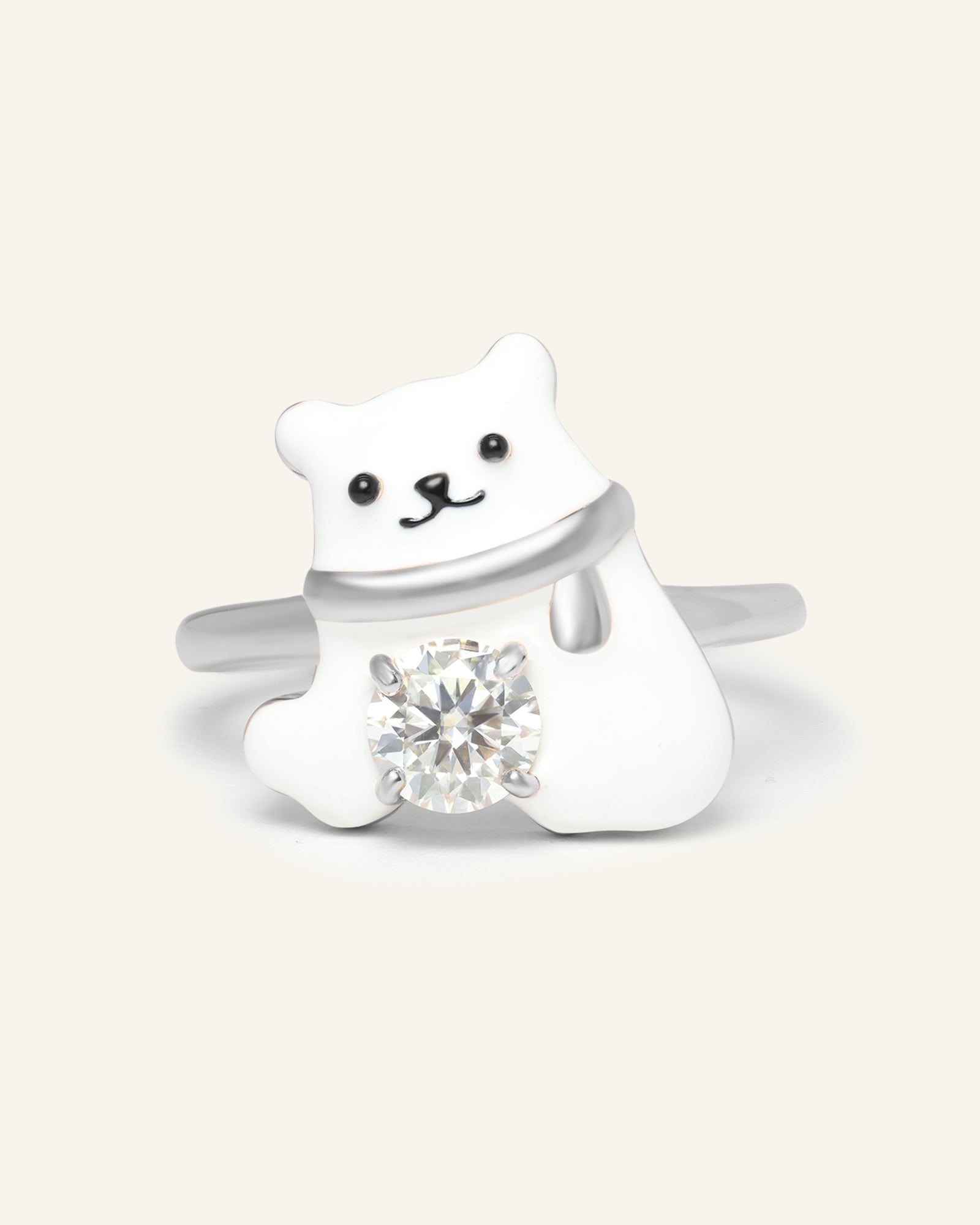 Polar Bear Moissanite Ring in silver, resting on a warm linen background