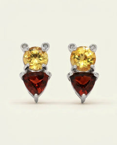 Pooh Origami Stud in silver, resting on a warm linen background