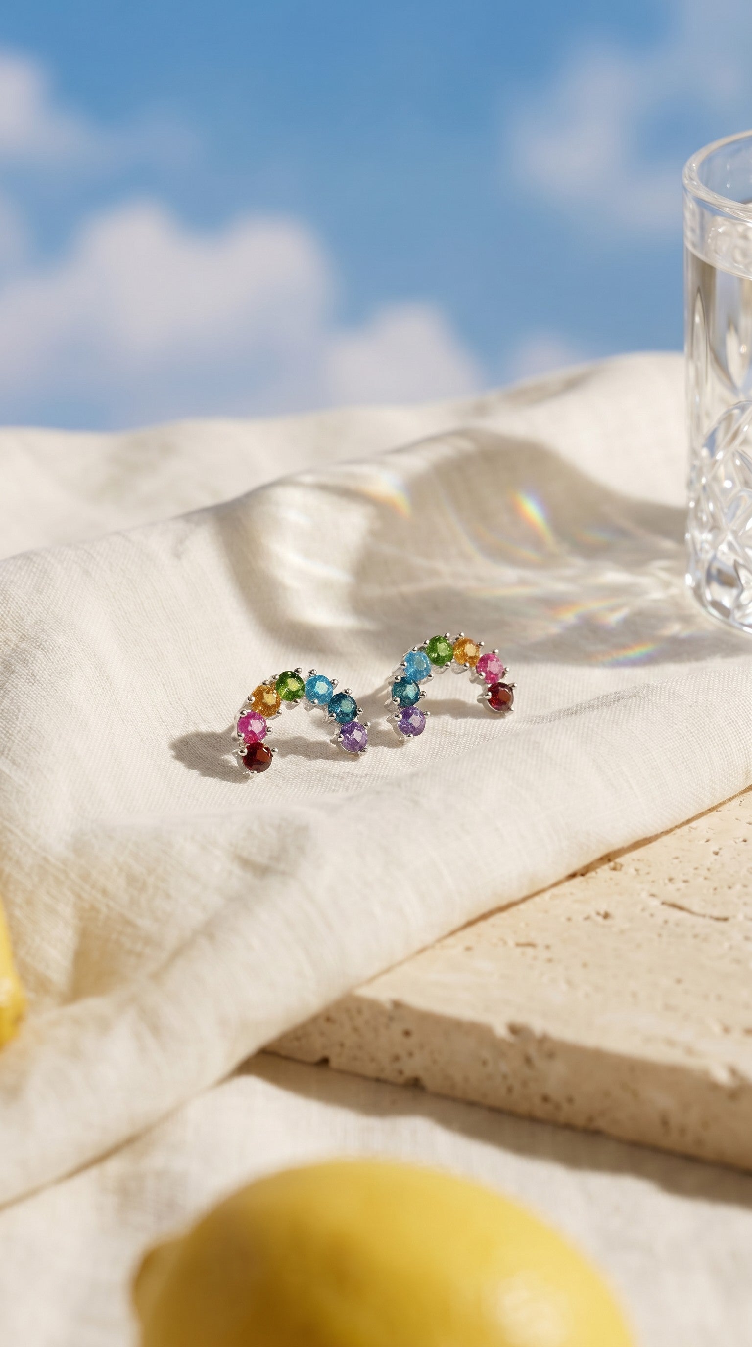 Love Estella natural gemstone rainbow arch stud earrings featuring garnet, pink topaz, citrine, diopside, apatite, London blue topaz, and amethyst.