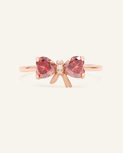 Close-up of the Ribbon Moissanite Ring in rose gold, resting on a warm linen background
