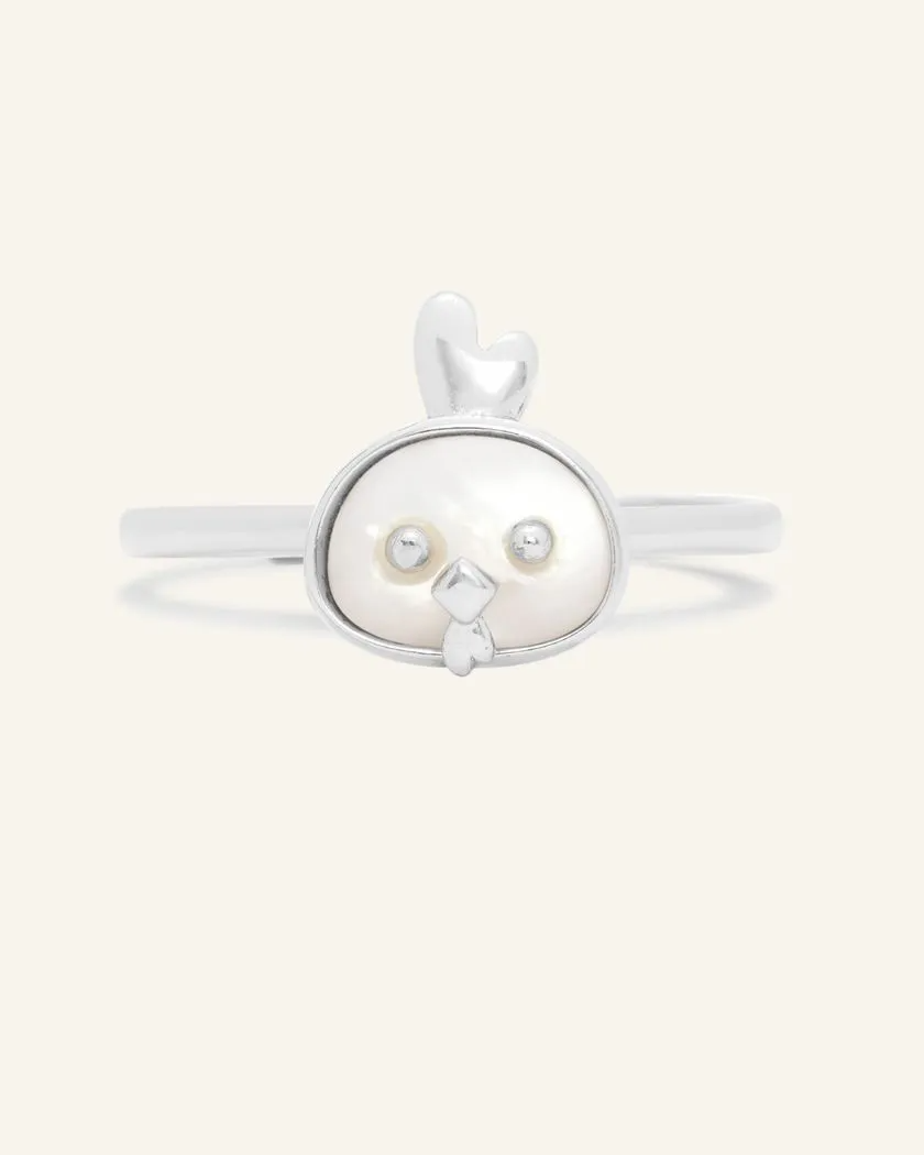 A delicate silver ring featuring a mother of pearl centerpiece shaped like a rooster's head.