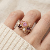 Model wearing the Rosette Floral Cluster Ring styled with a cozy cream sweater to show everyday elegance.