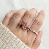Model wearing the Rosette Floral Cluster Ring styled with a cozy cream sweater to show everyday elegance.