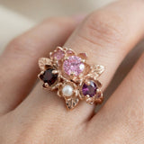 Macro photograph of the Rosette ring on a hand, highlighting the leaf details and pearl accent.