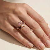 Full hand view of the Rosette Cluster Ring showing scale and the warm rose gold tones against the skin.