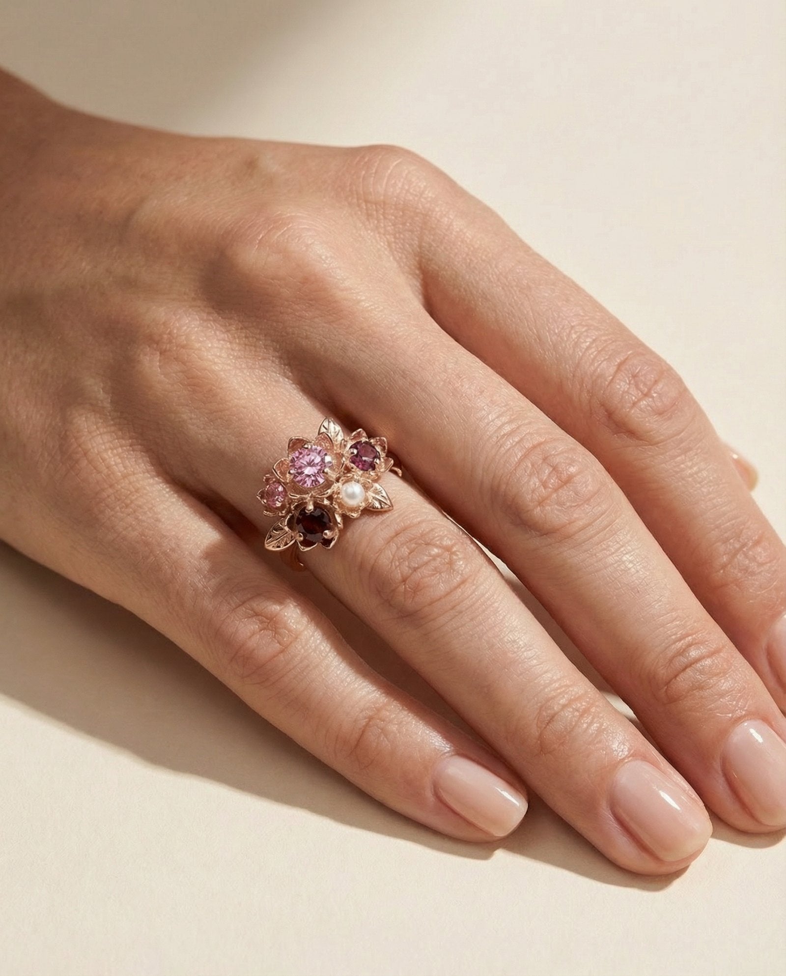 Full hand view of the Rosette Cluster Ring showing scale and the warm rose gold tones against the skin.