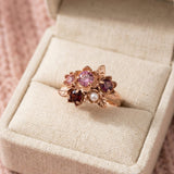 Rosette Floral Cluster Ring displayed in a luxury cream jewelry box with a soft pink knit background.