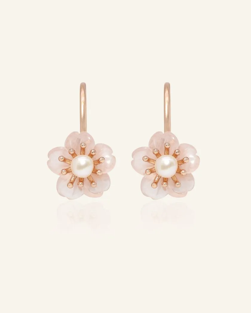 Rose gold sakura hook earrings featuring hand-carved rose quartz petals and a luminous freshwater pearl centerpiece.