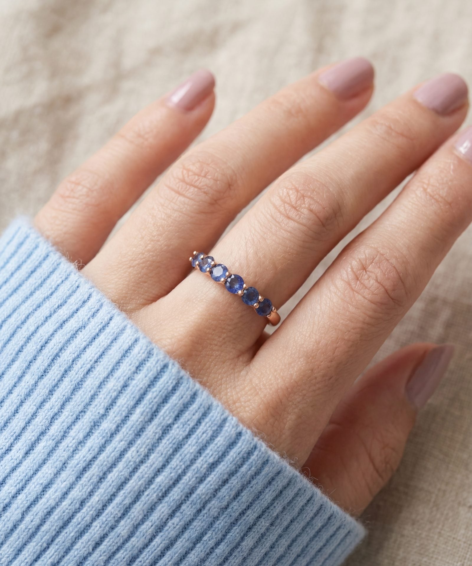 Sapphire Half Eternity Band in rose gold, worn on a model