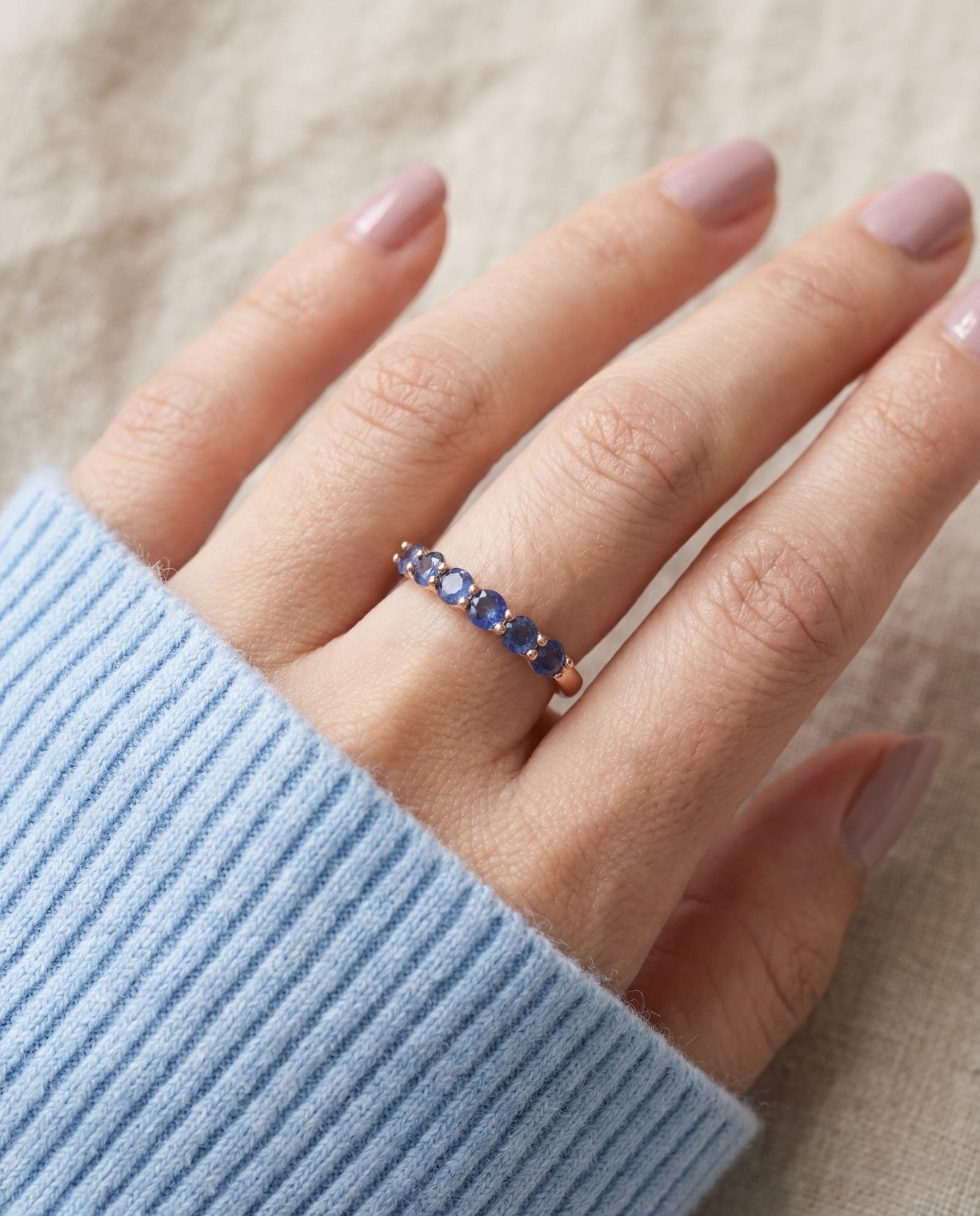 Sapphire Half Eternity Band in rose gold, worn on a model
