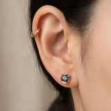 Side view of model wearing 18k rose gold Sculpted Heart Nest Moissanite Stud paired with a plain cartilage cuff.