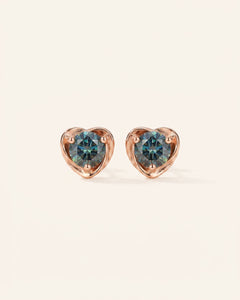 Pair of Sculpted Heart Nest Moissanite Stud Earrings in 18k rose gold vermeil with 5mm Celestial Teal stones.