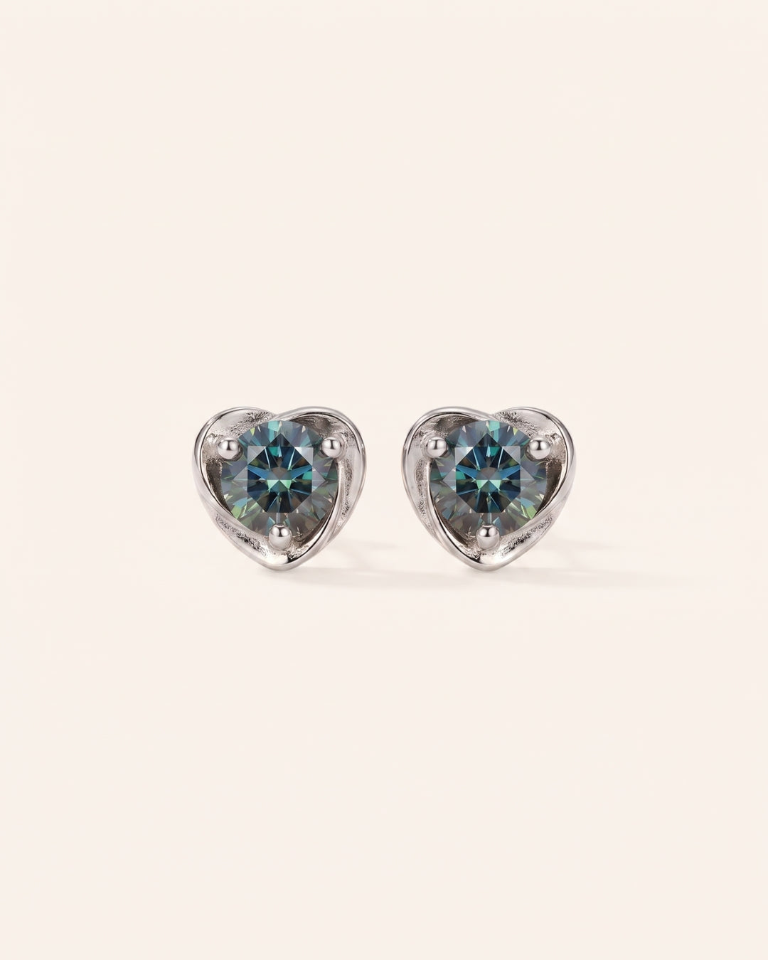 Pair of Sculpted Heart Nest Moissanite Stud Earrings in sterling silver featuring round Celestial Teal moissanite center stones.