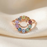 Smiley Ring | Moissanite in rose gold, laid flat on a tabletop