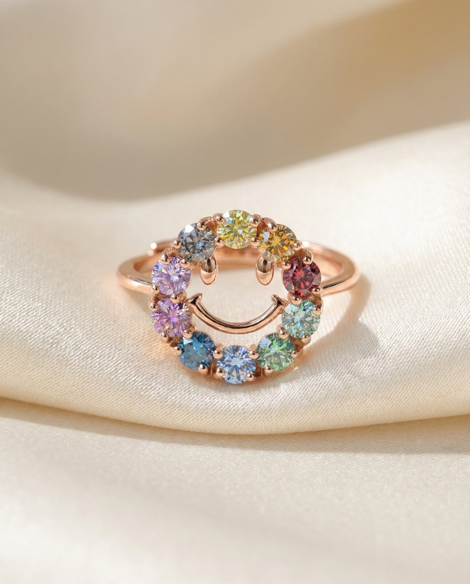 Smiley Ring | Moissanite in rose gold, laid flat on a tabletop