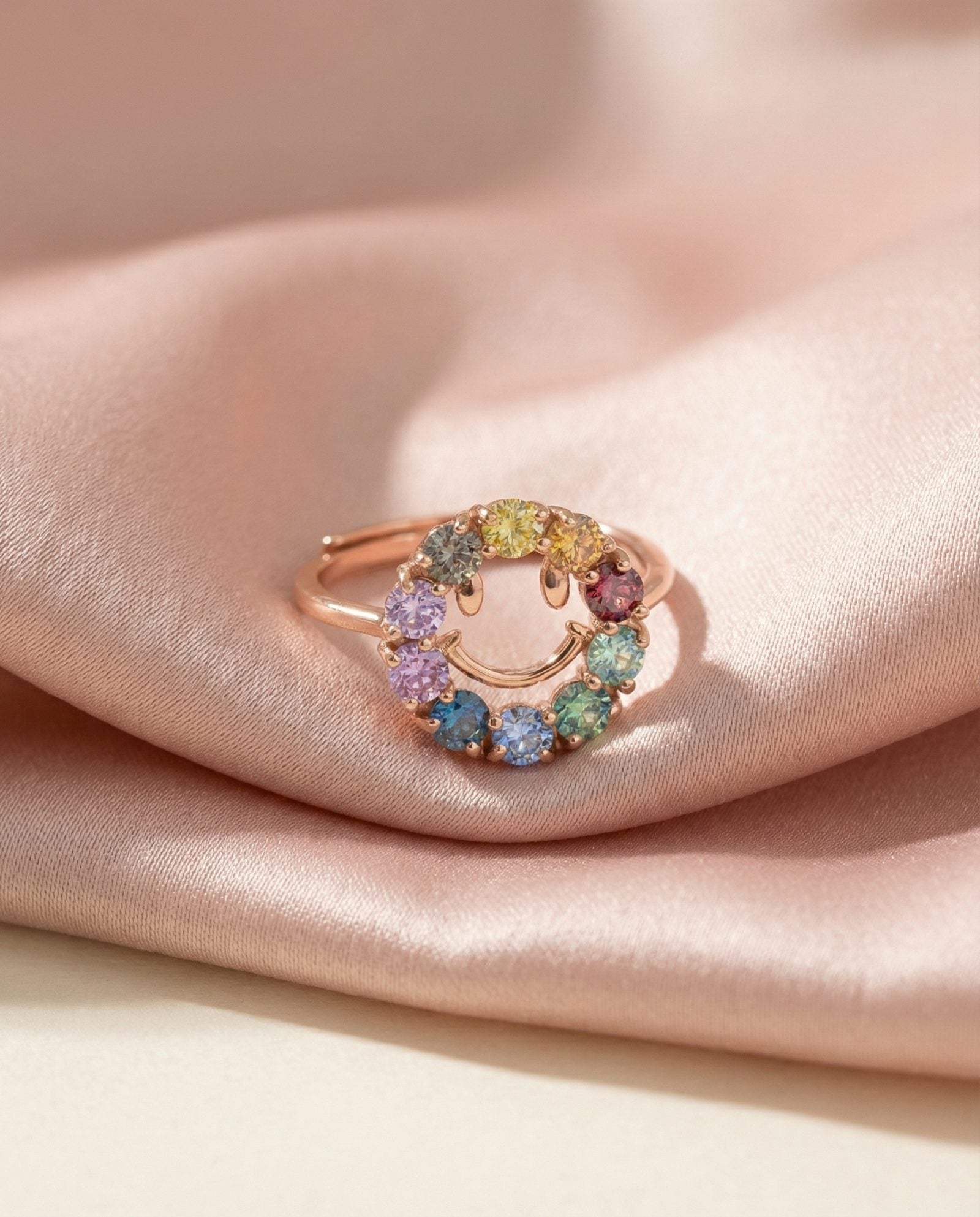 Smiley Ring | Moissanite in rose gold, laid flat on a tabletop