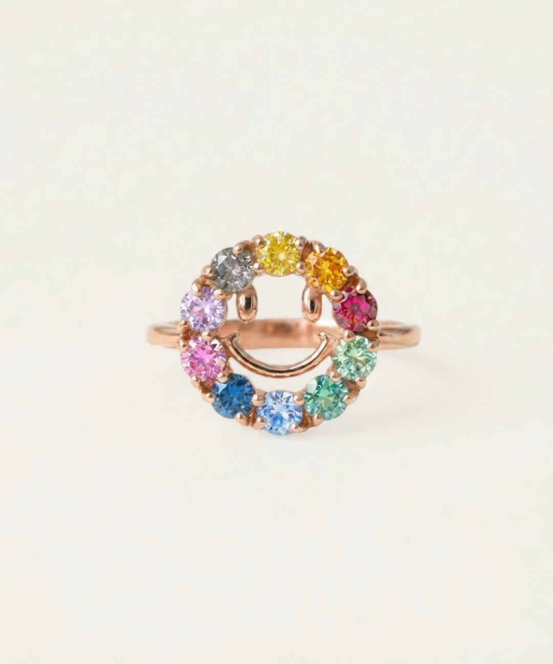 Close-up of the Smiley Ring | Moissanite in rose gold, resting on a warm linen background